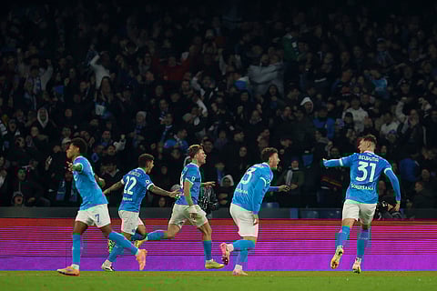 Napoli's Rasmus Hojlund, centre, celebrates after scoring his side's second goal during the Serie A soccer match between Napoli and Juventus, in Naples, Italy.