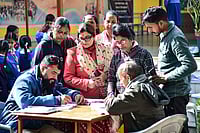 PTI; Representative image : Booth Level Officers (BLOs) collect enumeration forms from voters.