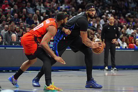 Dallas Mavericks forward Anthony Davis (3) looks to move the ball against Houston Rockets guard Josh Okogie (20) during the second half of an NBA basketball game in Dallas.