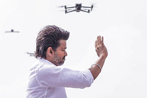 Tamilaga Vettri Kazhagam (TVK) chief Vijay waves to the gathering during a public meeting, in Puducherry. 