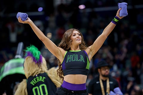 A member of the New Orleans Pelicans PelSquad dances during the fourth quarter of an NBA basketball game against the San Antonio Spurs in New Orleans.