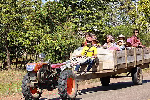 In this photo released by Agence Kampuchea Press (AKP), a Cambodian family sit on a tractor as they flee form their home in Preah Vihear province, Cambodia.