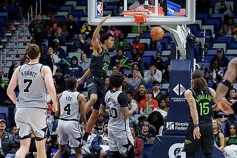 New Orleans Pelicans forward Trey Murphy III (25) reacts after a dunk against San Antonio Spurs forward Julian Champagnie (30) during the fourth quarter of an NBA basketball game in New Orleans.