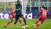 | Photo: AP/Luca Bruno : Inter Milan's Marcus Thuram challenges for the ball with Liverpool's Andrew Robertson during their UEFA Champions League  league phase match on December 9, 2025.