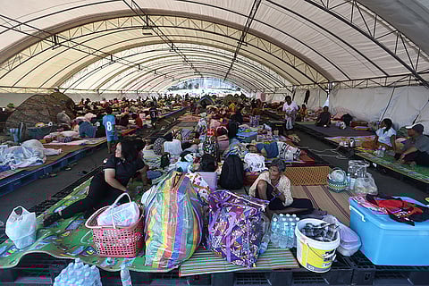 Thai residents who fled homes following clashes between Thai and Cambodian soldiers rest at an evacuation center in Buriram province, Thailand.