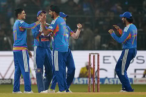 India's Arshdeep Singh, centre, celebrates with teammates the wicket of South Africa's Quinton de Kock during the first T20 International cricket match between India and South Africa in Cuttack.