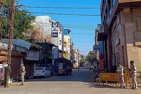 Police personnel stand guard at a closed market during the 'Bastar Bandh' called by Sarva Adiwasi Samaj, in Jagdalpur, Bastar district. 