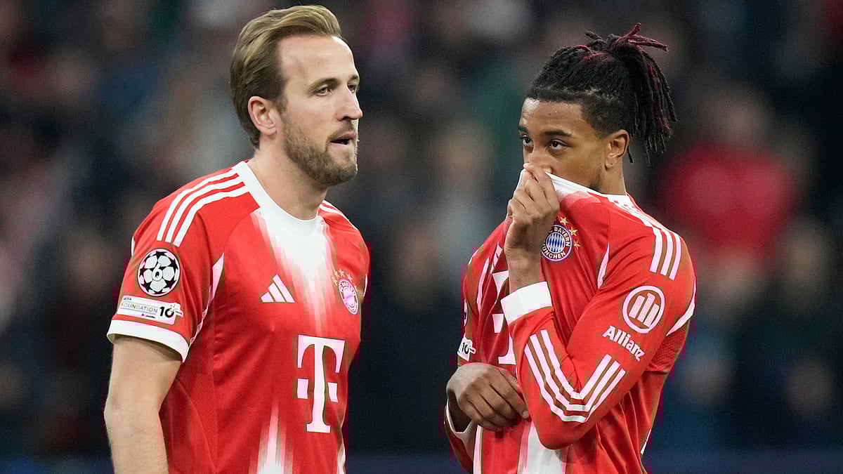 Bayern Munich's Michael Olise talks to Harry Kane during the UEFA Champions League opening phase match against Sporting CP on December 9, 2025.  - | Photo: AP/Matthias Schrader
