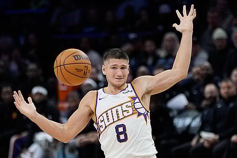 Phoenix Suns guard Grayson Allen (8) loses control of the ball during the second half of an NBA basketball game against the Minnesota Timberwolves in Minneapolis. 