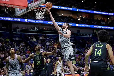 San Antonio Spurs center/forward Luke Kornet (7) shoots against New Orleans Pelicans center Yves Missi (21) during the fourth quarter of an NBA basketball game in New Orleans.
