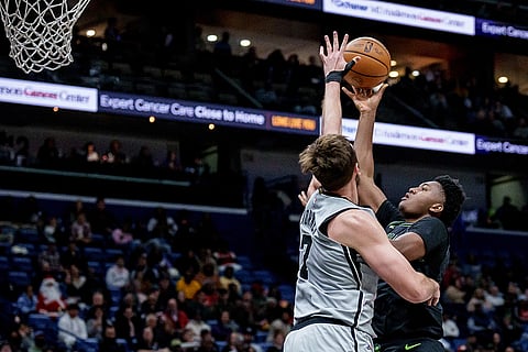 New Orleans Pelicans center Derik Queen (22) shoots against San Antonio Spurs center/forward Luke Kornet (7) during the first half of an NBA basketball game in New Orleans.