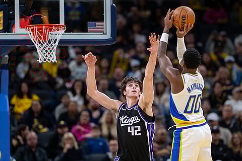 Sacramento Kings center Maxime Raynaud (42) reaches for a shot by Indiana Pacers guard Bennedict Mathurin (00) during the first half of an NBA basketball game in Indianapolis.