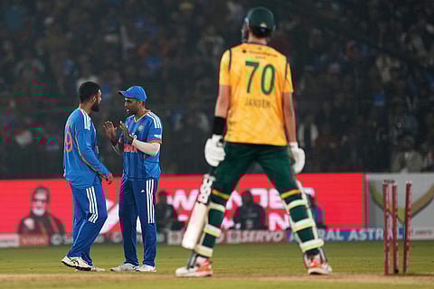 India's Varun Chakaravarthy, left, and India's captain Suryakumar Yadav celebrate the wicket of South Africa's Marco Jansen, right, during the first T20 International cricket match between India and South Africa in Cuttack.