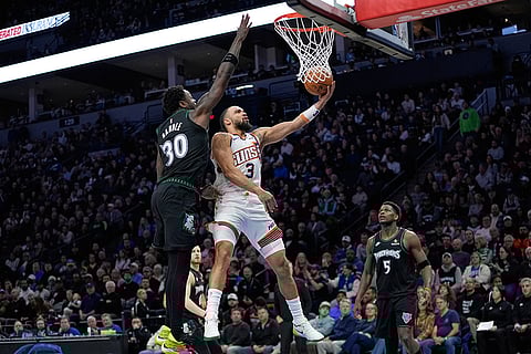 Phoenix Suns forward Dillon Brooks (3) shoots while defended by Minnesota Timberwolves forward Julius Randle (30) during the second half of an NBA basketball game in Minneapolis. 