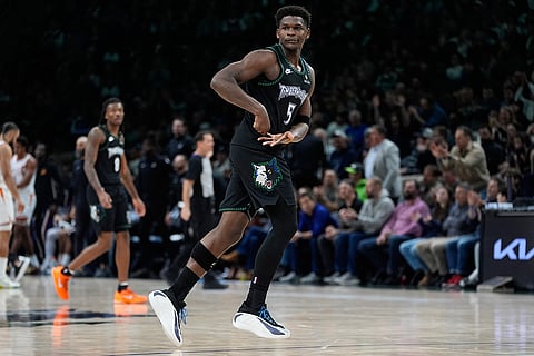 Minnesota Timberwolves guard Anthony Edwards (5) celebrates after making a shot during the second half of an NBA basketball game against the Phoenix Suns in Minneapolis. 