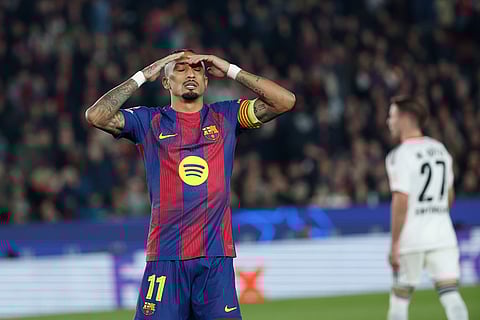 Barcelona's Raphinha reacts after a missing opportunity to score during the Champions League opening phase soccer match between Barcelona and Eintracht Frankfurt in Barcelona, Spain.