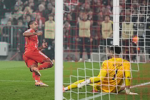 Bayern's Serge Gnabry, left, scores his side's opening goal during the Champions League opening phase soccer match between FC Bayern Munich and Sporting CP in Munich, Germany.