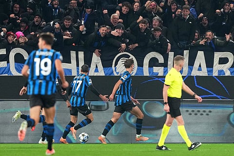 Atalanta's Charles De Ketelaere, center, celebrates after scoring his side's second goal during the Champions League opening phase soccer match between Atalanta and Chelsea, in Bergamo, Italy.