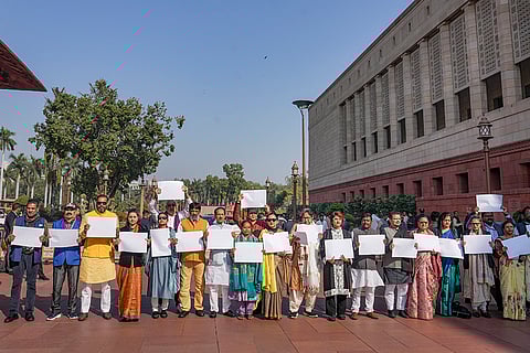 Trinamool Congress (TMC) MPs Kirti Azad, Yusuf Pathan, Dola Sen, Sagarika Ghose, Saayoni Ghosh and others hold blank white papers as they stage a protest demanding the government to come out with a white paper on funds allocated to West Bengal under the MGNREGS and PMAY, during the Winter session of Parliament, in New Delhi, Wednesday, Dec. 10, 2025. 