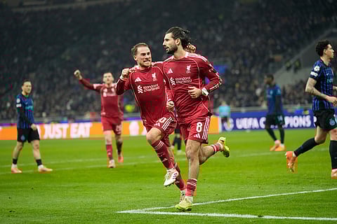 Liverpool's Dominik Szoboszlai celebrates after scoring his side's first goal from a penalty shot during a Champions League, league phase, soccer match between Inter Milan and Liverpool in Milan, Italy.