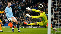 | Photo: AP/Dave Thompson : Champions League playoff first leg: Manchester City's Erling Haaland shoots to score past Real Madrid's goalkeeper Thibaut Courtois