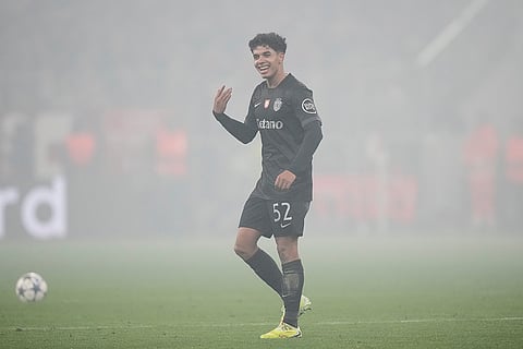 Sporting's Joao Simoes reacts as a smoke from flares fills the field during the Champions League opening phase soccer match between FC Bayern Munich and Sporting CP in Munich, Germany.