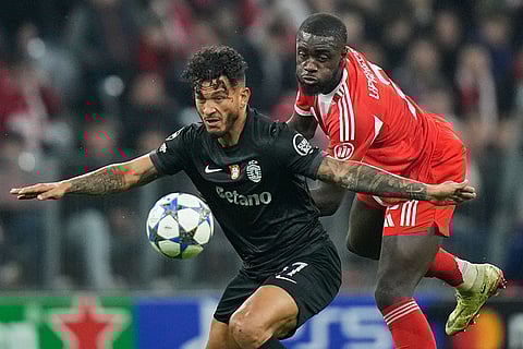 Bayern's Dayot Upamecano, right, challenges for the ball with Sporting's Luis Suarez during the Champions League opening phase soccer match between FC Bayern Munich and Sporting CP in Munich, Germany.