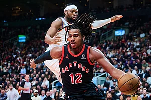 | Photo: Sammy Kogan/The Canadian Press via AP : Toronto Raptors' Collin Murray-Boyles (12) drives past New York Knicks' Guerschon Yabusele (28) during the first half of an NBA Cup basketball game in Toronto.