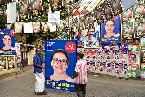 Political parties members put up posters ahead of the first phase of Kerala local body polls, in Ernakulam district, Kochi, Kerala.