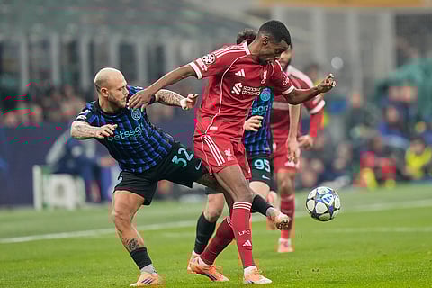 Liverpool's Alexander Isak, right, challenges for the ball with Inter Milan's Federico Dimarco during a Champions League, league phase, soccer match between Inter Milan and Liverpool in Milan, Italy.