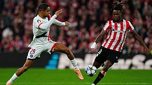 | Photo: AP/Miguel Oses : PSG's Bradley Barcola and Athletic Bilbao's Nico Williams challenge for the ball during their UEFA Champions League opening phase match on December 10, 2025.
