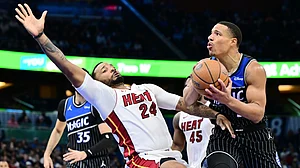 Desmond Bane #3 of the Orlando Magic draws a foul from Norman Powell #24 of the Miami Heat in the second half of a Emirates NBA Cup Quarterfinals game at Kia Center on December 09, 2025 in Orlando, Florida.