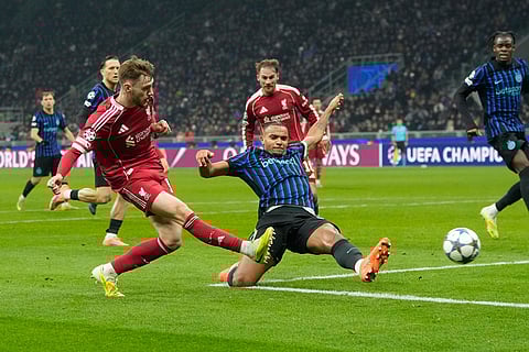 Liverpool's Conor Bradley, left, takes a shot at goal during a Champions League, league phase, soccer match between Inter Milan and Liverpool in Milan, Italy