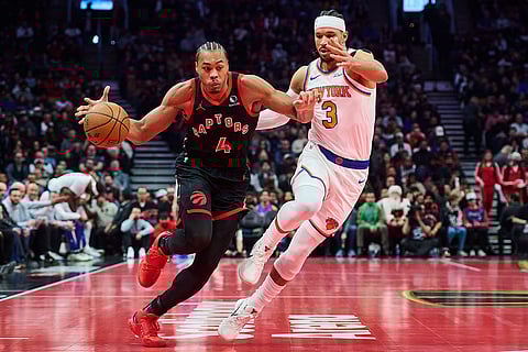 Toronto Raptors' Scottie Barnes (4) drives past New York Knicks' Josh Hart (3) during the first half of an NBA Cup basketball game in Toronto.