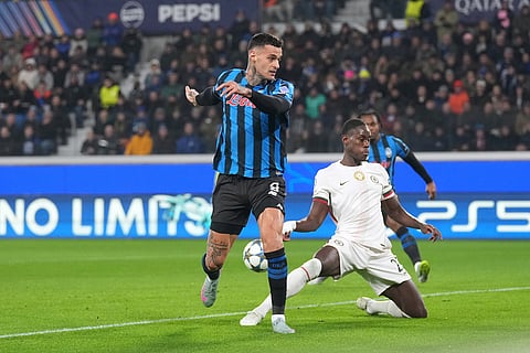 Atalanta's Gianluca Scamacca, left, attempts a shot at goal during the Champions League opening phase soccer match between Atalanta and Chelsea, in Bergamo, Italy.