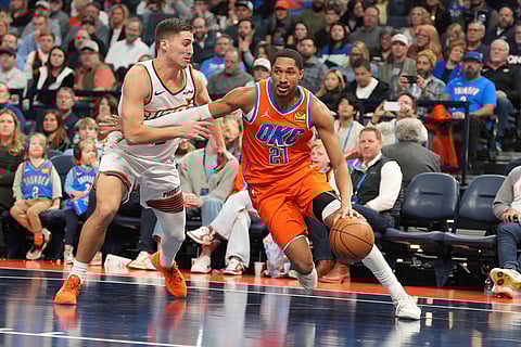 Oklahoma City Thunder guard Aaron Wiggins, right, drives past Phoenix Suns guard Collin Gillespie, left, during the second half of an NBA Cup basketball game in Oklahoma City.