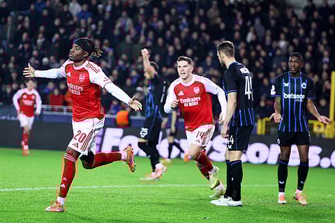 Arsenal's Noni Madueke, left, celebrates after scoring his sides second goal during the Champions League opening phase soccer match between Club Brugge and Arsenal in Bruges, Belgium.