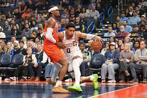 Phoenix Suns forward Ryan Dunn (0) pushes past Oklahoma City Thunder guard Shai Gilgeous-Alexander during the first half of an NBA Cup basketball game in Oklahoma City.