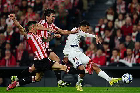 PSG's Senny Mayulu, right, triess to score as Athletic Bilbao's Yuri Berchiche and Daniel Vivian try to stop him during of the Champions League opening phase soccer match between Athletic Bilbao and PSG in Bilbao, Spain.