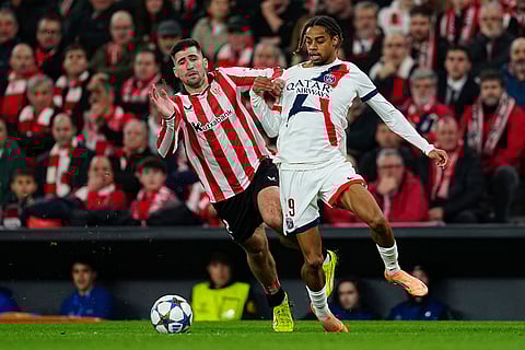Athletic Bilbao's Jesus Areso, left, and PSG's Bradley Barcola challenge for the ball during of the Champions League opening phase soccer match between Athletic Bilbao and PSG in Bilbao, Spain.