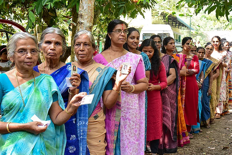 Voters wait in a queue to cast votes during the second phase of the Kerala local body elections, in Thrissur, Kerala. | REP IMAGE | - | Photo: PTI