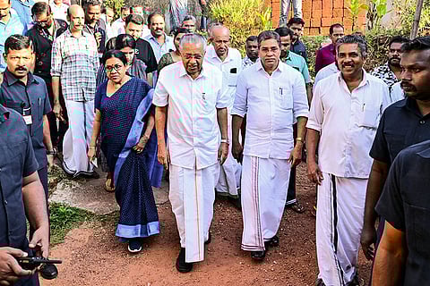 Kerala Chief Minister Pinarayi Vijayan, third from right, with family members arrives to cast his vote at a polling booth during the second phase of the state local body elections, in Kannur, Kerala.