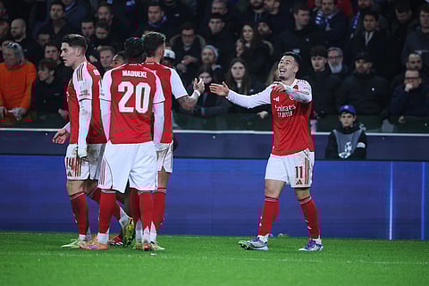Arsenal's Gabriel Martinelli, right, celebrates after scoring his sides third goal during the Champions League opening phase soccer match between Club Brugge and Arsenal in Bruges, Belgium.