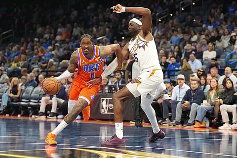 Oklahoma City Thunder guard Jalen Williams, left, drives past Phoenix Suns center Mark Williams, right, during the second half of an NBA Cup basketball game in Oklahoma City. 