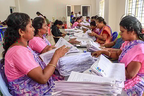 Electoral staff segregate forms of the special intensive revision (SIR) of electoral rolls, in Tirunelveli, Tamil Nadu.