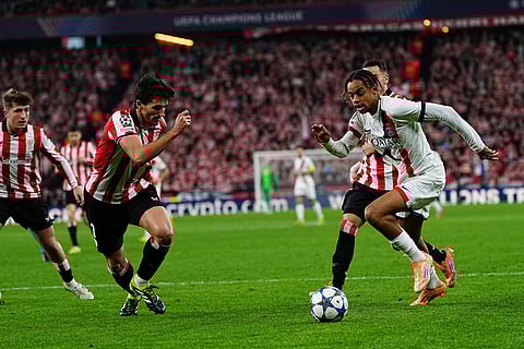 PSG's Bradley Barcola, right, is challenged by Athletic Bilbao's Daniel Vivian during the Champions League opening phase soccer match between Athletic Bilbao and PSG in Bilbao, Spain.