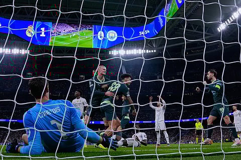 Manchester City's Nico O'Reilly, center, celebrates with temmates after scoring their side's first goal during a Champions League opening phase soccer match between Real Madrid and Manchester City, in Madrid, Spain.