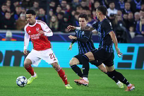 Arsenal's Ethan Nwaneri, left, is pursued by Brugge's Aleksandar Stankovic, right, during the Champions League opening phase soccer match between Club Brugge and Arsenal in Bruges, Belgium.