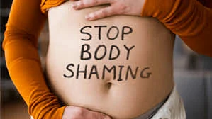 Stop Body Shaming written on a belly