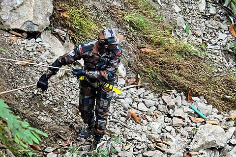 An Indian Army personnel during a search and rescue operation after a minitruck carrying 21 construction workers from Assam plunges into a deep gorge, in , Arunachal Pradesh.